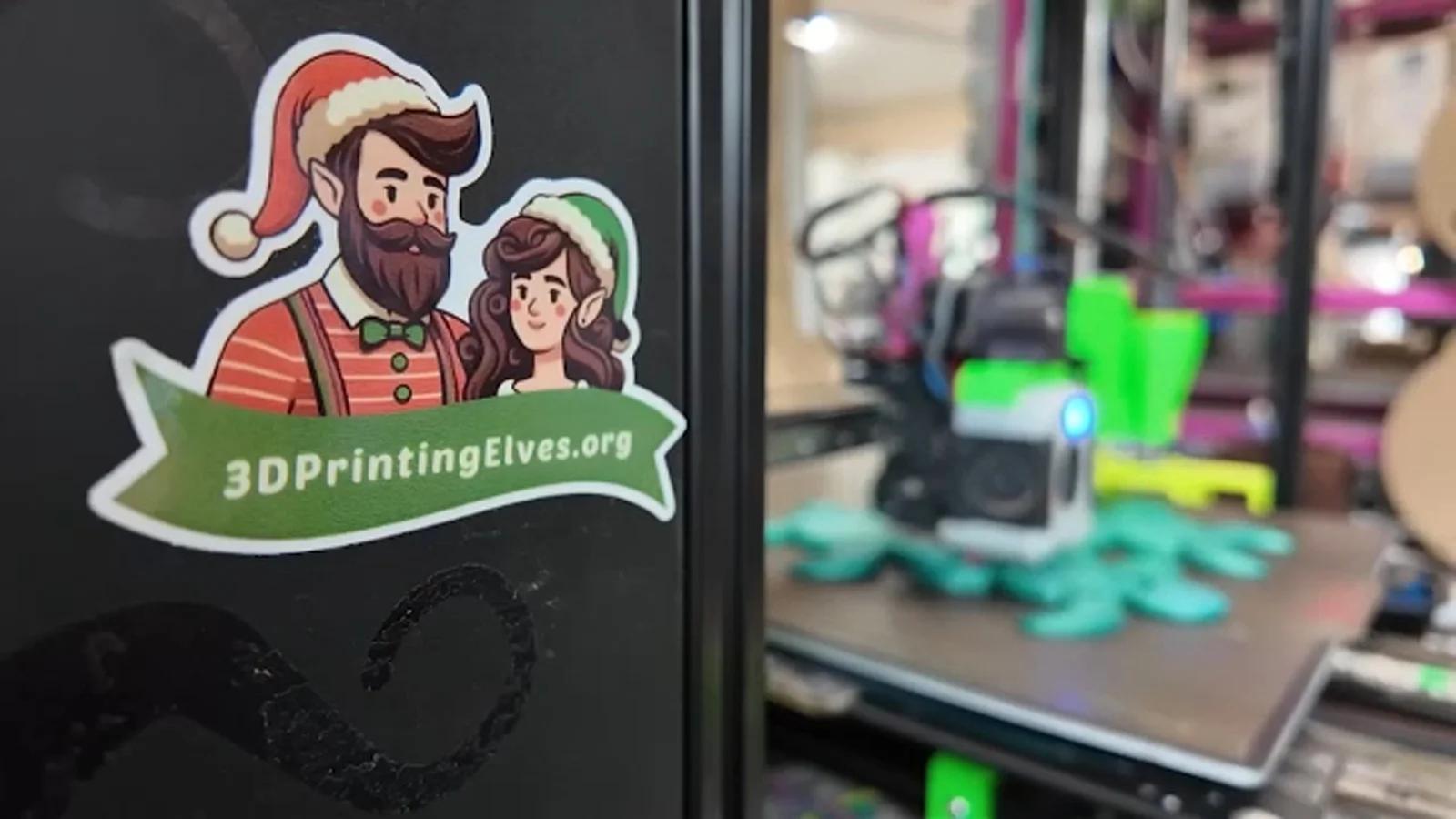3D Printing Elves workshop with a desktop 3D printer producing an articulated toy
