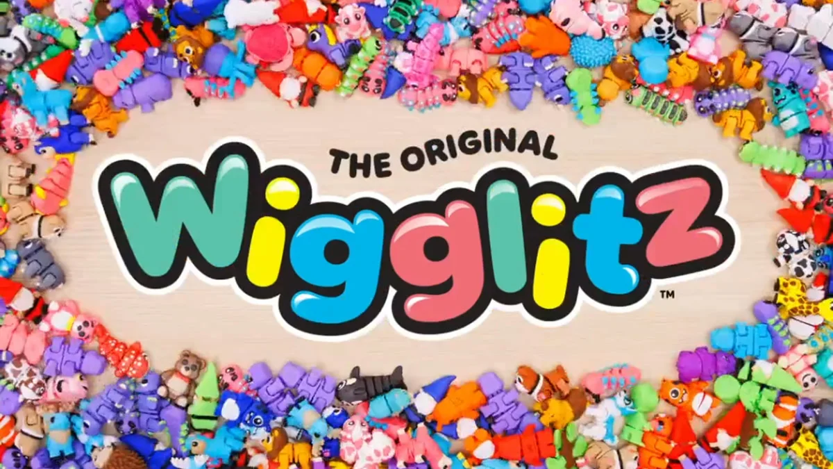 A pile of colorful 3D printed flexi toys with the Wigglitz logo
