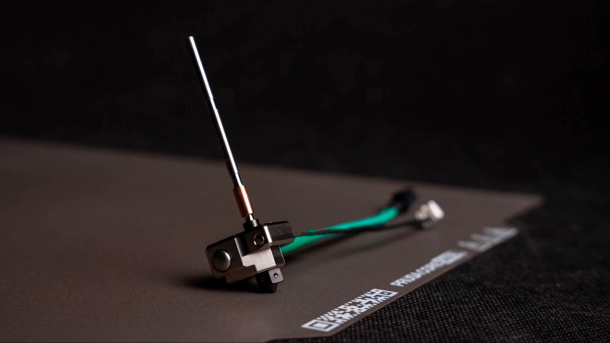 Close-up of a high-temperature 3D printer hotend with hardened nozzle and heater wiring