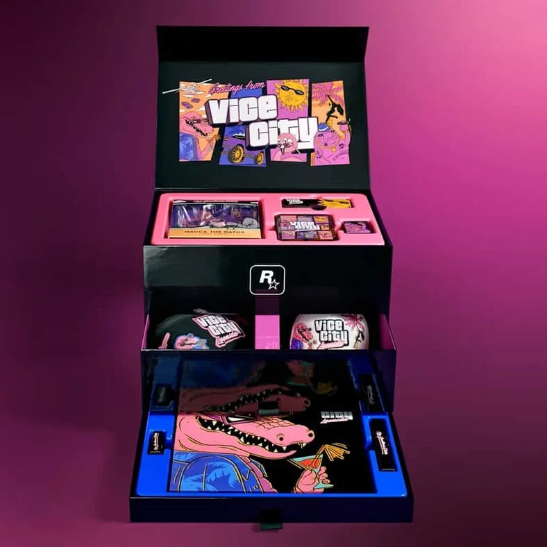The open GTA 6 Collector's Box showing its tiered trays of merchandise including drinkware, a matchbook and a poster
