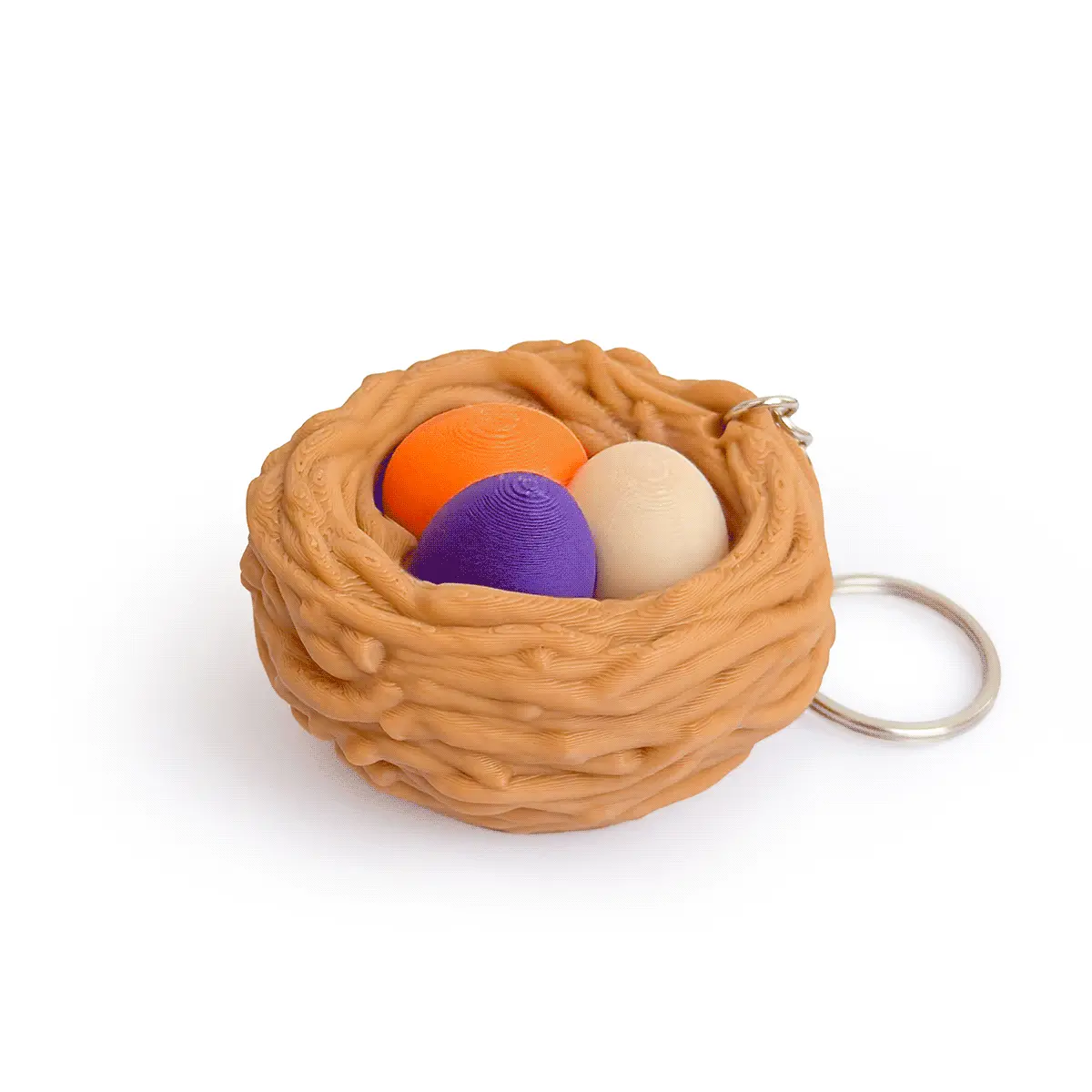 3D printed bird nest fidget clicker keychain with three colorful eggs